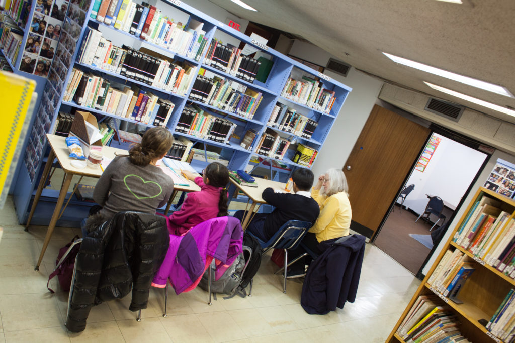 Star Learning Center's space with two desks with tutors and book shelves all around.