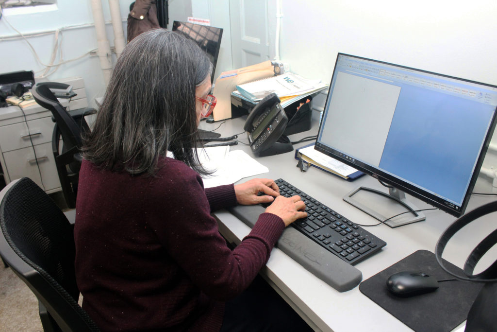 A woman working on a desktop computer