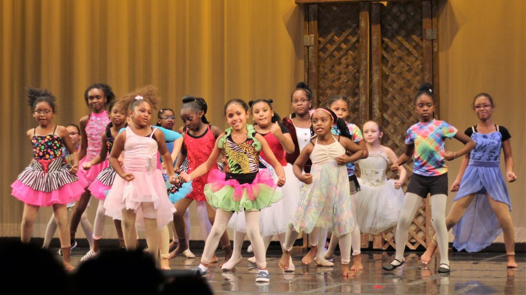 A group of girls on stage during the Performing Arts Conservatory's final performance in 2019.
