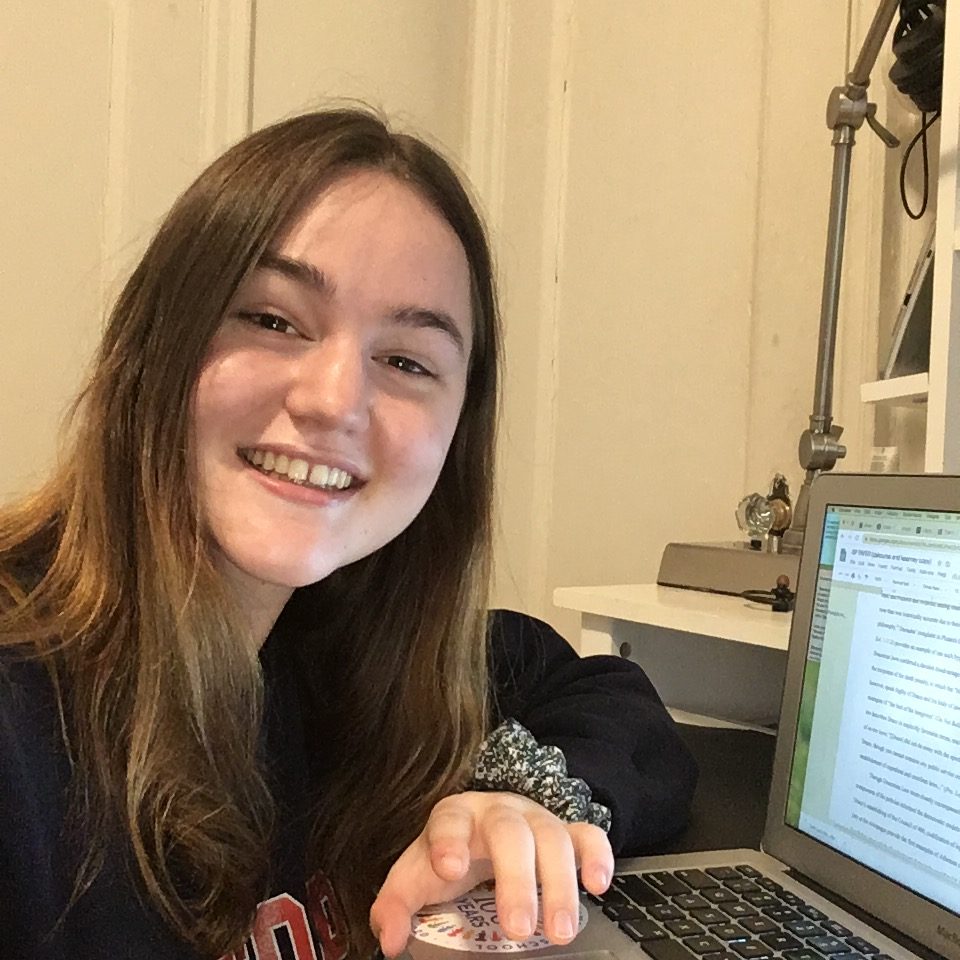 A young woman with her laptop participating during the COVID-19 Pandemic.