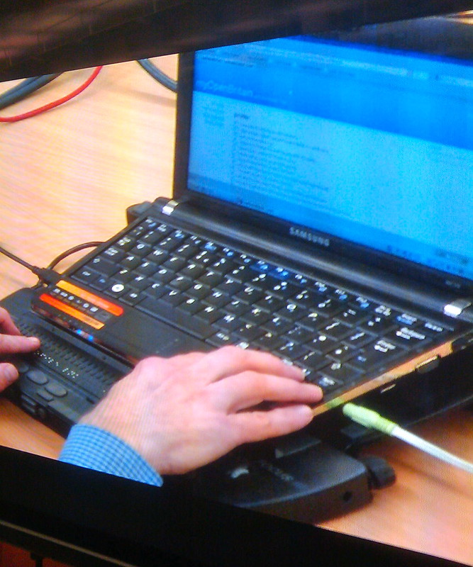 A person using a laptop with a screen reader 