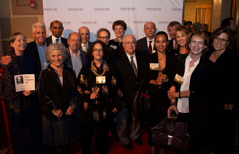 Approximately 20 board members stand in front of a Goddard Riverside backdrop at the 2019 Annual Gala.