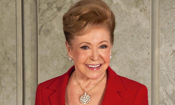 Author photo of Mary Higgins Clark in a bright red jacket