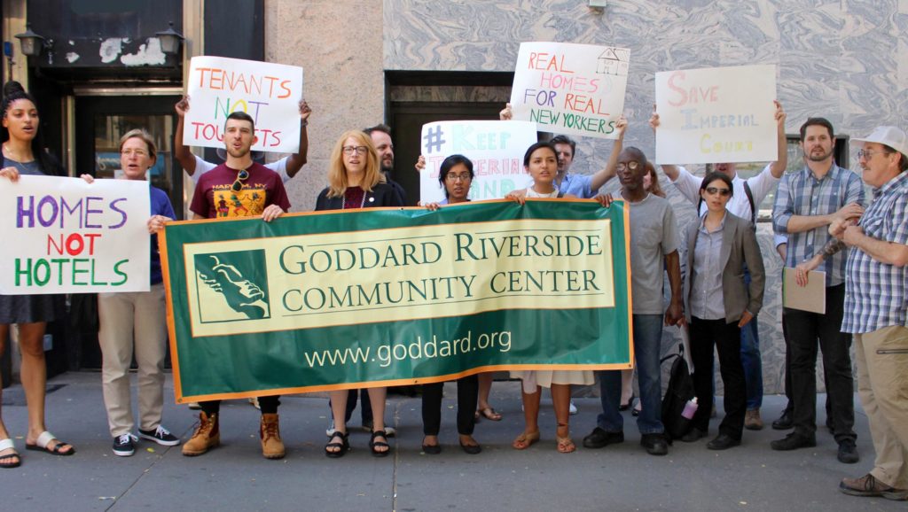 Assemblywoman Linda Rosenthal, tenants and staffers from the Goddard Riverside Law Project hold a Goddard banner and signs reading Homes not Hotels.