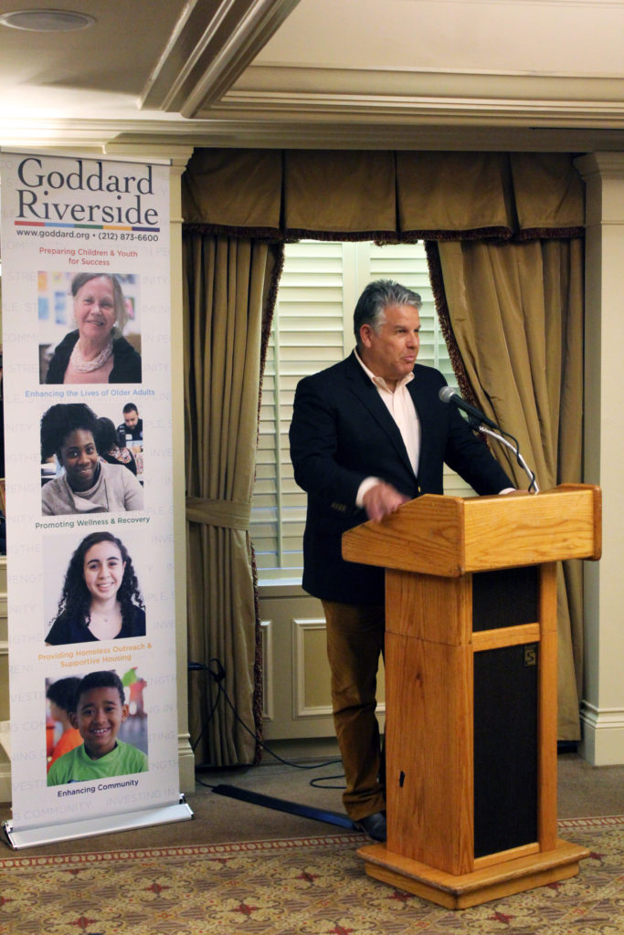 Bill Cohan standing in front of a podium speaking at the 2019 Goddard Gold event.