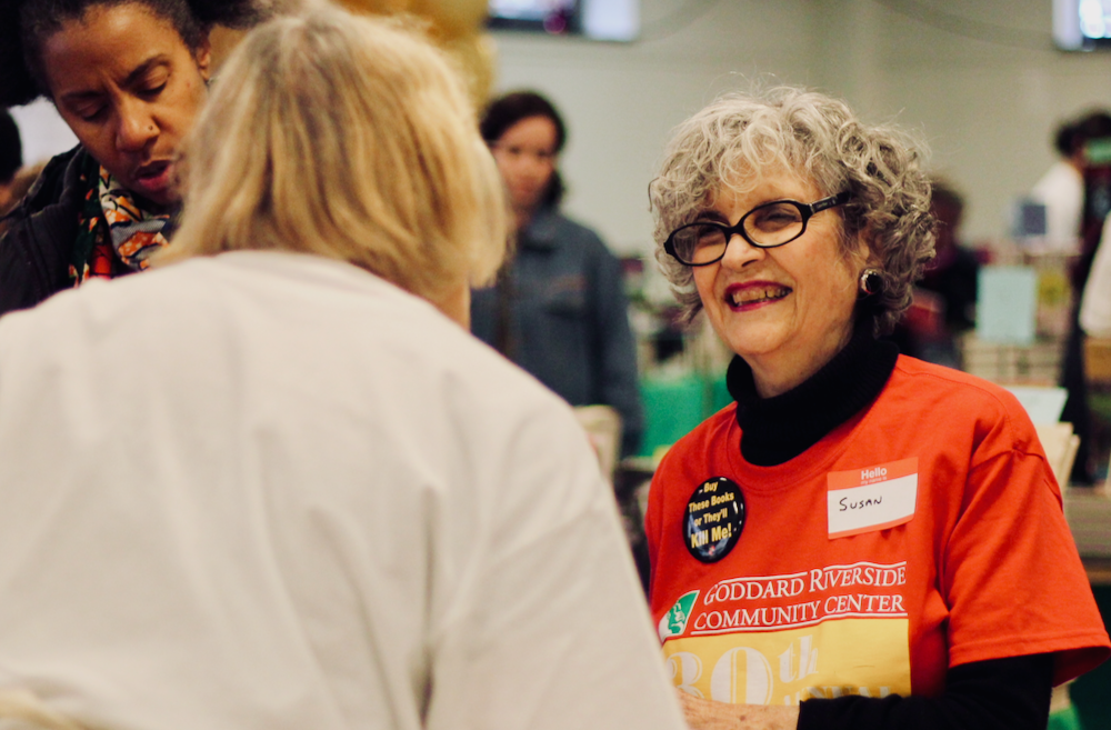 A smiling Susan Richman assists a customer at the Goddard Book Fair