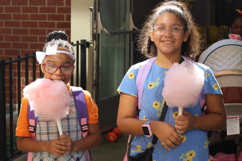 Two children holding cotton candy