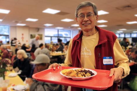 Volunteer Glenn Kubota helped carry food to the tables.