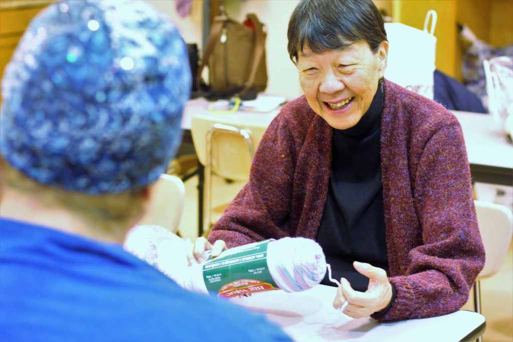 Pauline discusses a new project with friends in the Senior Center knitting group. 