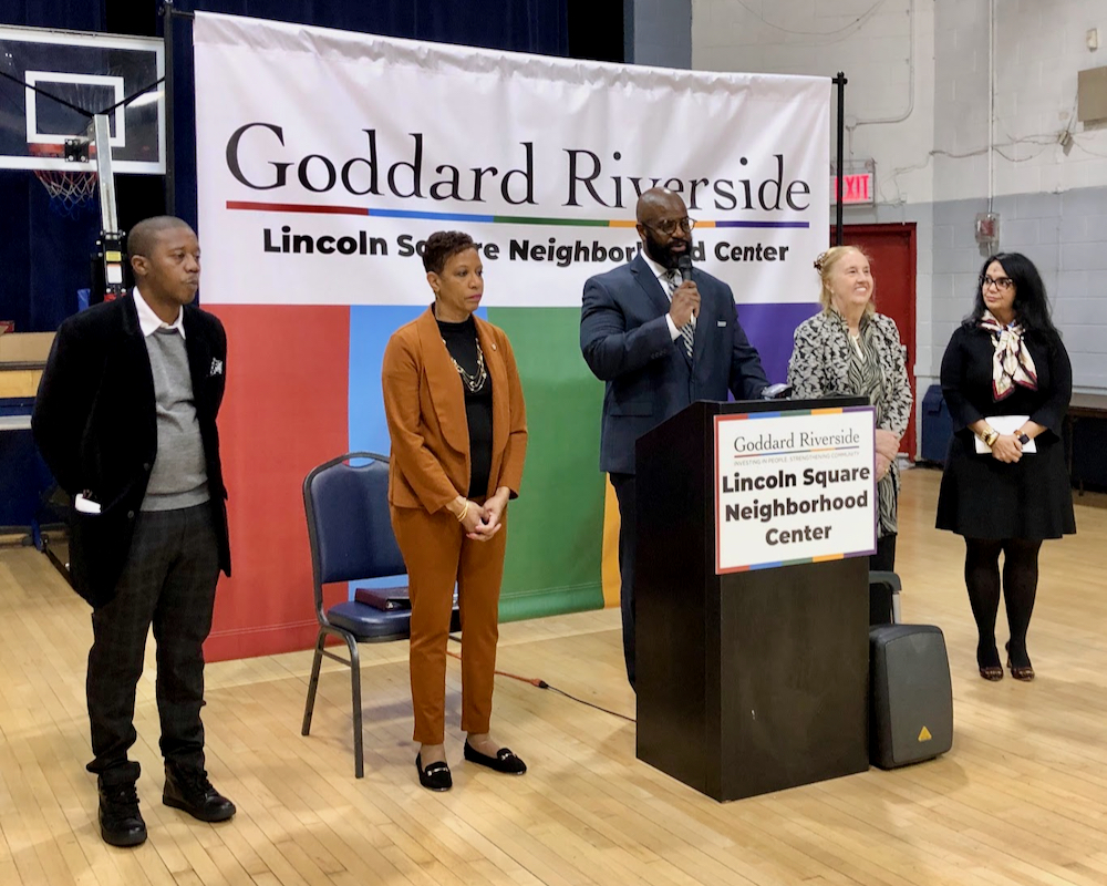 Five people standing behind Goddard Riverside banner.