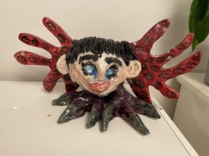 A sculpture in black, purple and red called Harpy