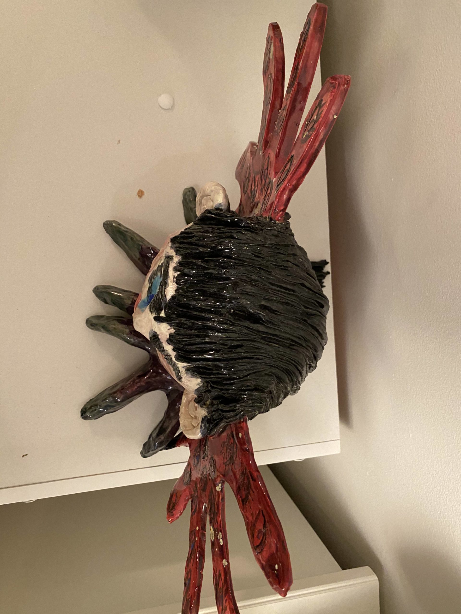 A sculpture in black, purple and red called Harpy