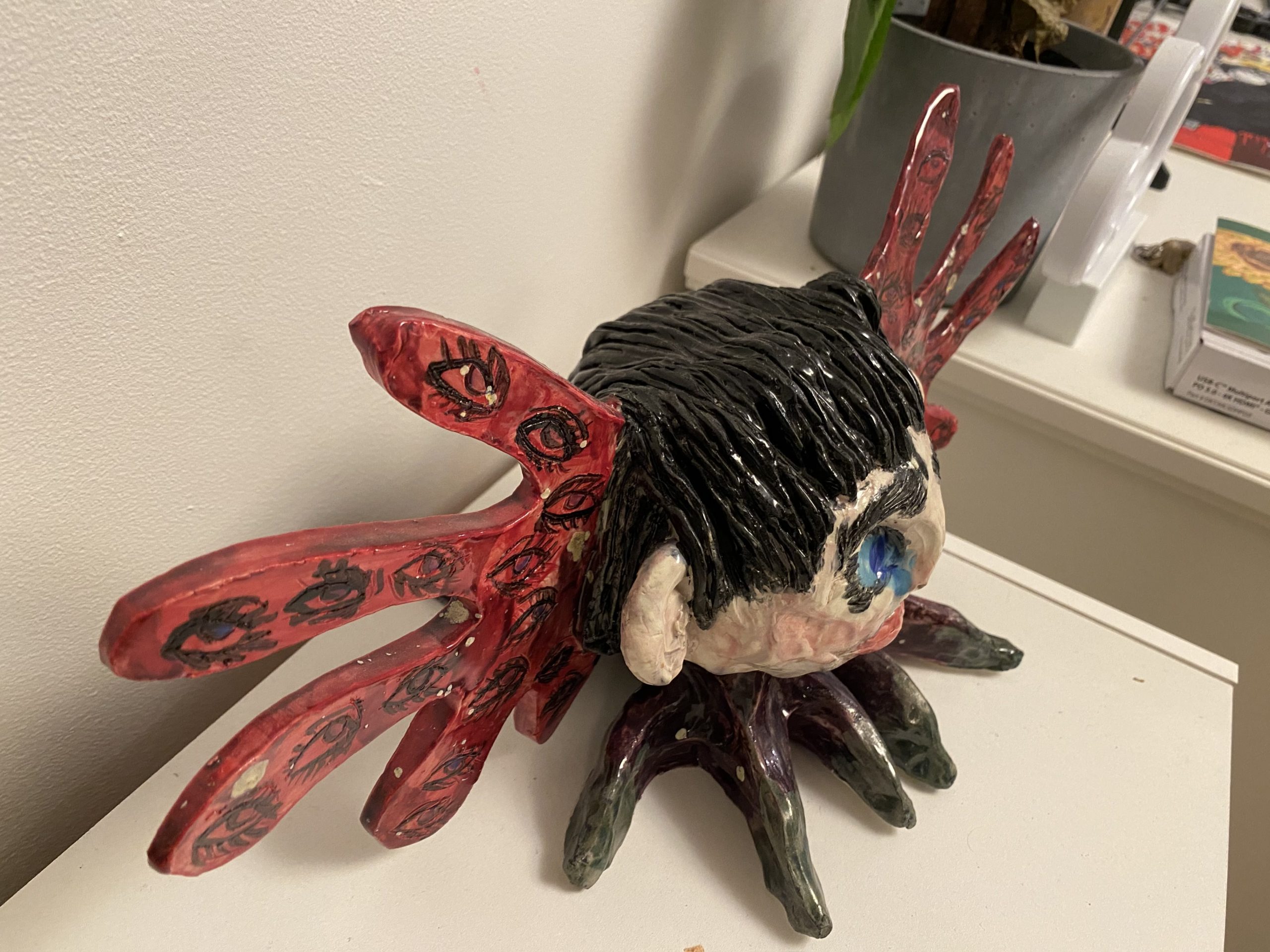 A sculpture in black, purple and red called Harpy