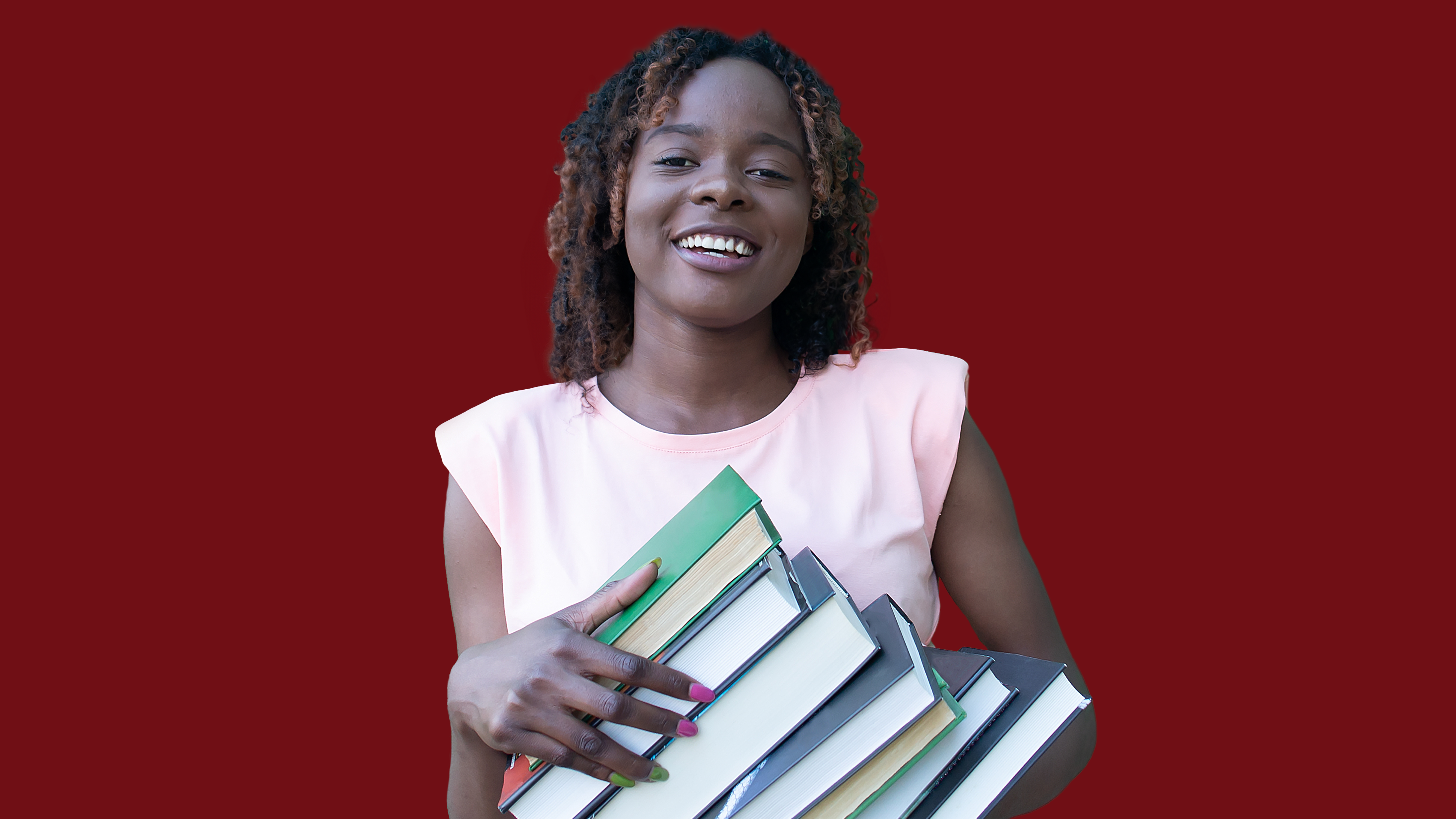 A young woman holding text books.