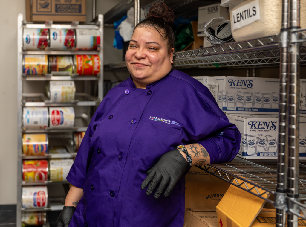 A woman standing in a pantry.